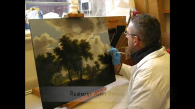 Restorer Alan Brown carefully working on restoring an oil painting at The Original Artwork Store.